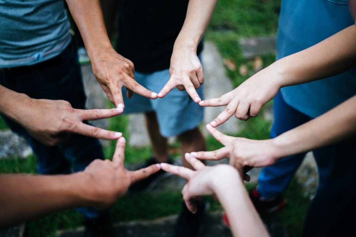 Top 12 Best Team Building Companies In Malaysia 2025 7 Teambuilding participants form a star with their fingers