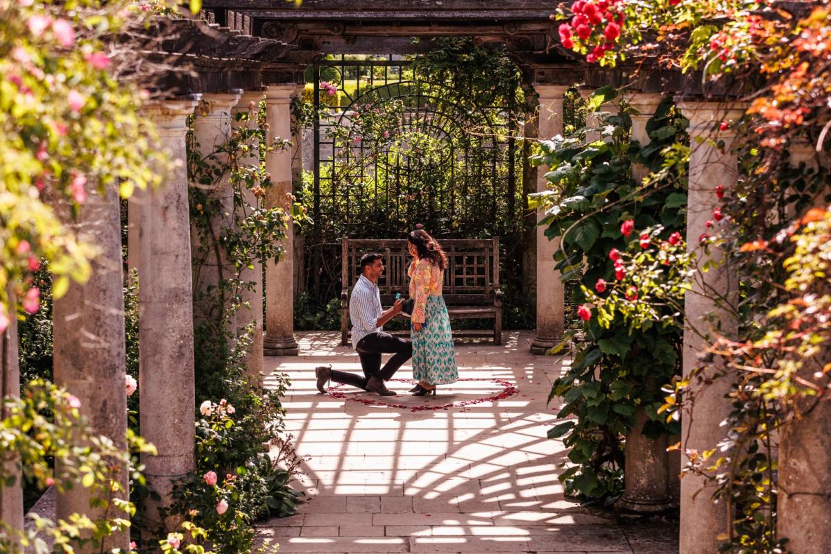 Top 20 Best Proposal Ideas in Malaysia 2025 17 Man proposes in a garden filled with blooming flowers