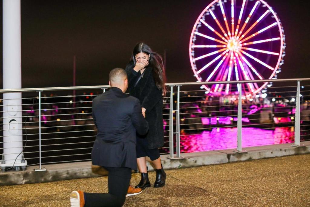 Top 20 Best Proposal Ideas in Malaysia 2025 10 Man proposing at night with Ferris wheel backdrop
