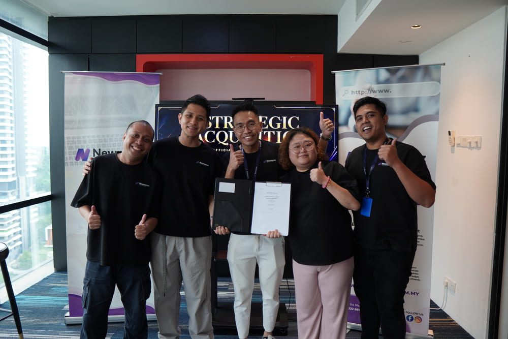 Newnormz Just Got Bigger And Malaysian Businesses Are Set to Benefit 3 Newnormz and Weitzen team members celebrating the completion of the strategic acquisition agreement during an office signing session in Malaysia.